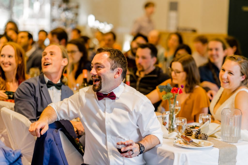 groom laughing at reception